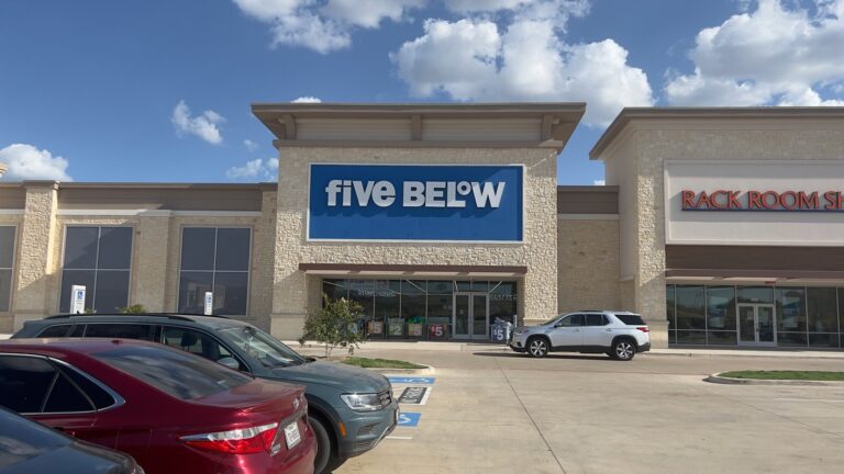 Fachada de una tienda Five Below con el rótulo azul y blanco visible sobre la entrada.